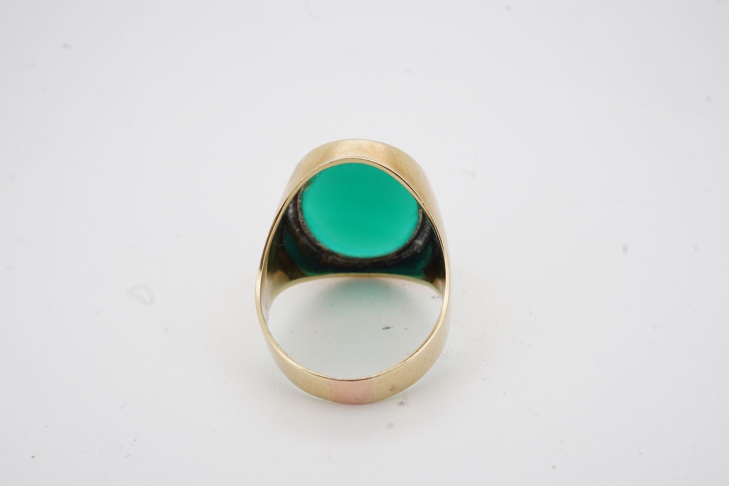 A yellow metal (stamped 585) and single stone oval chrysoprase set signet ring, size U, gross weight 8.4 grams.
